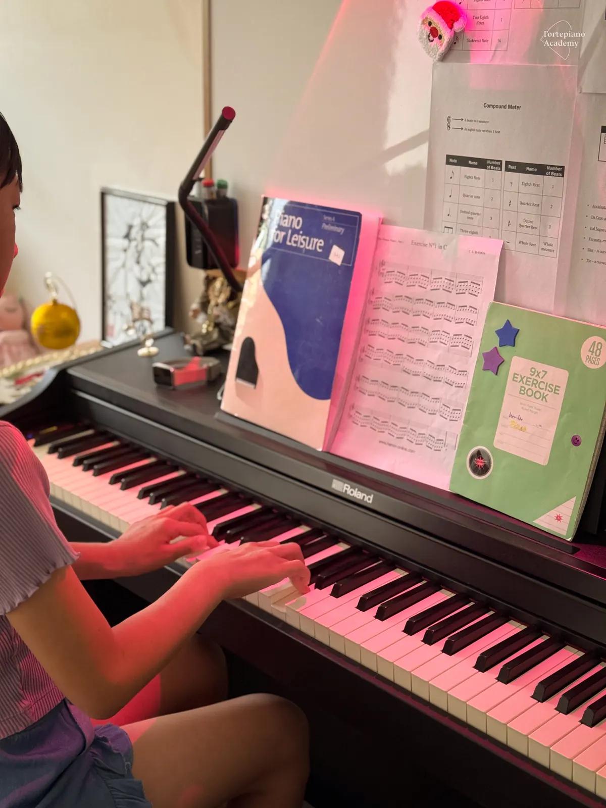 Young piano student practising during a structured lesson