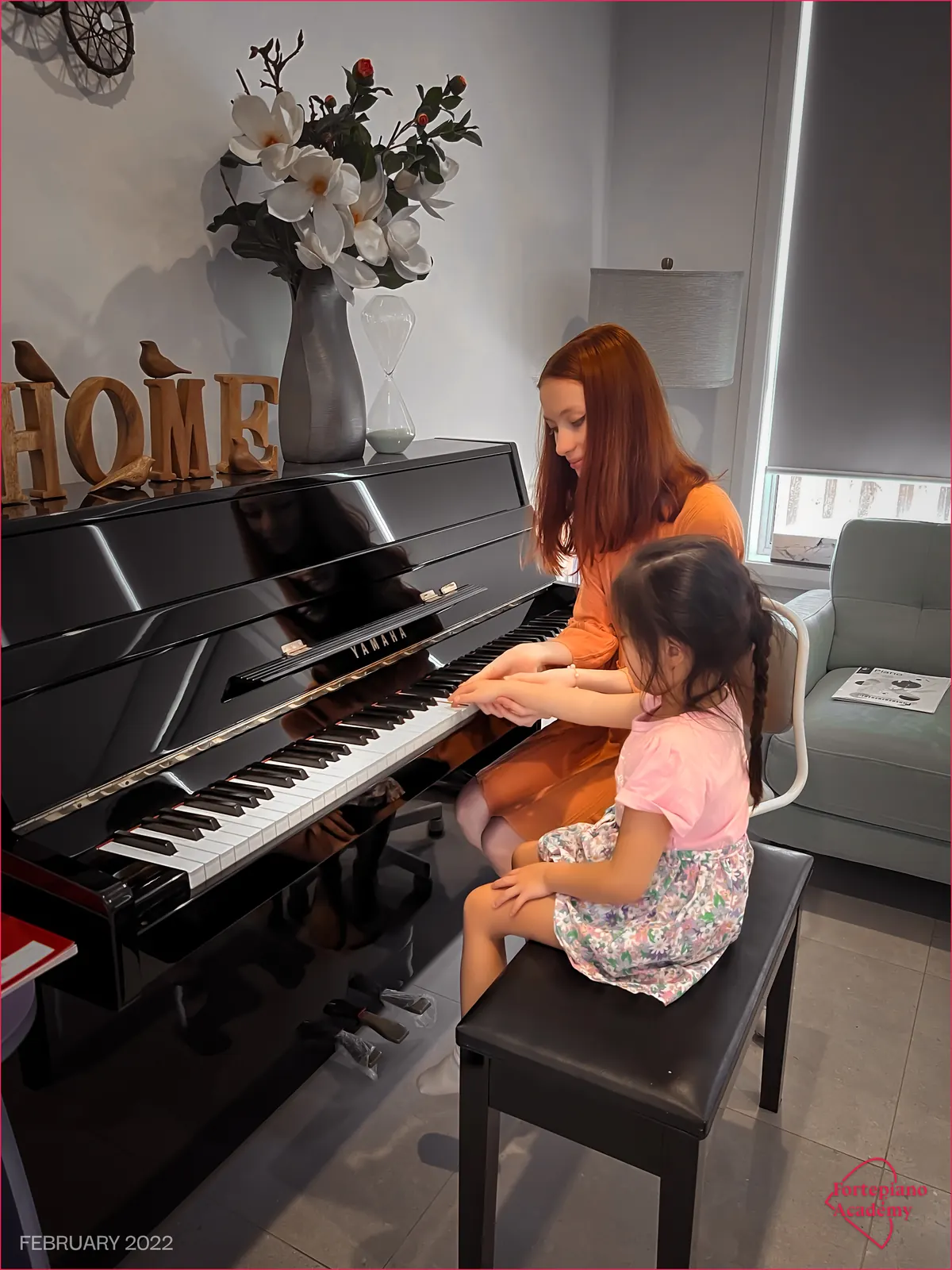 Liana guiding a young Fortepiano Academy student at the piano